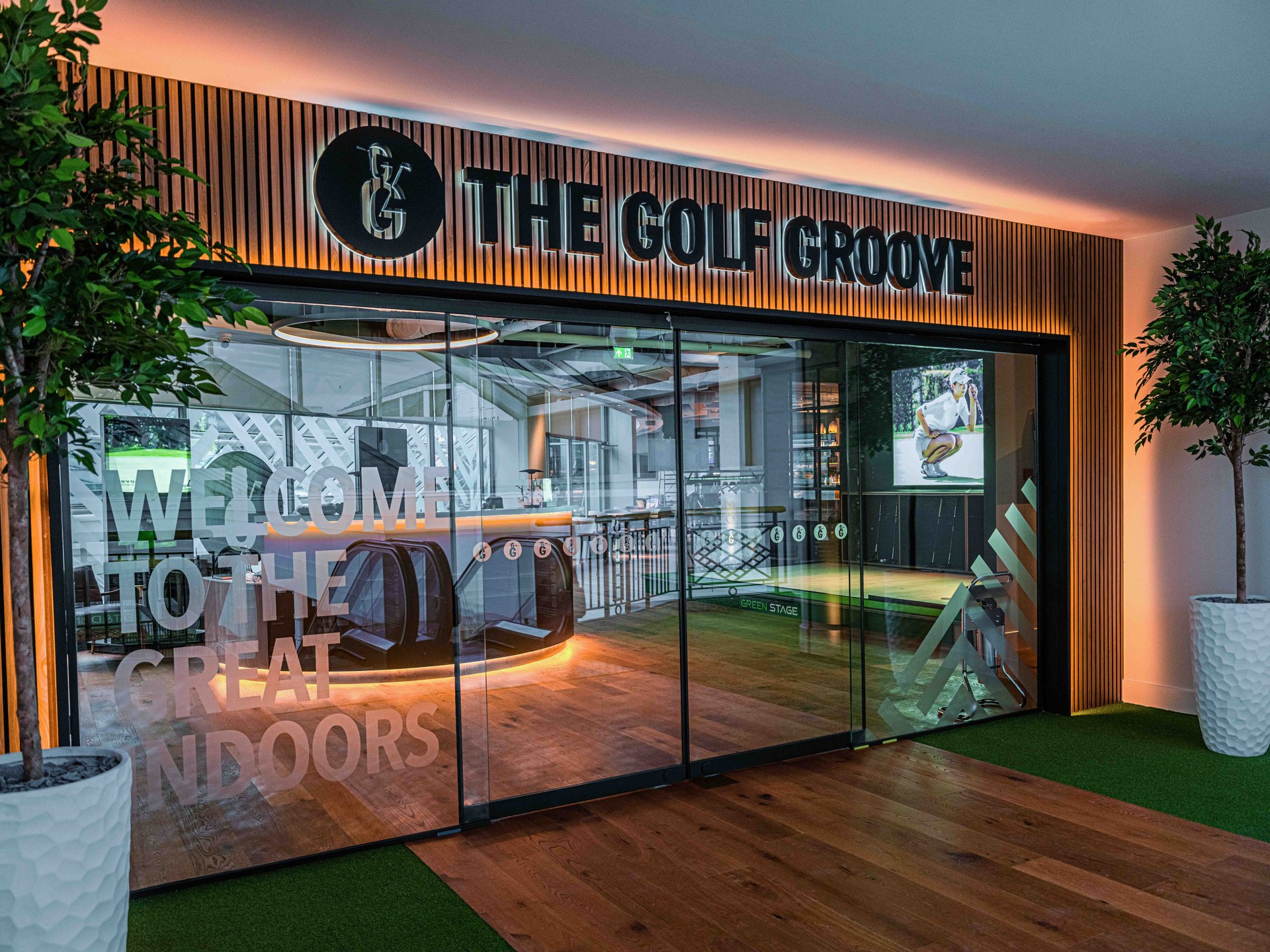 The Golf Groove entrance with the illuminated venue logo above the glass frontage